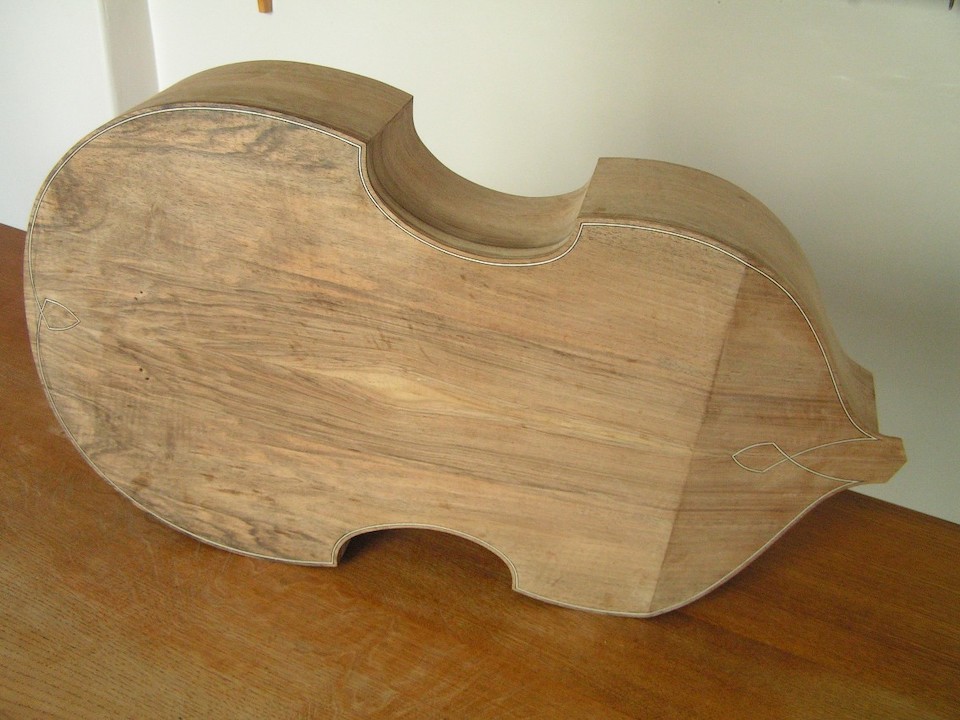 The back trimmed flush with the ribs and the purfling inlaid.